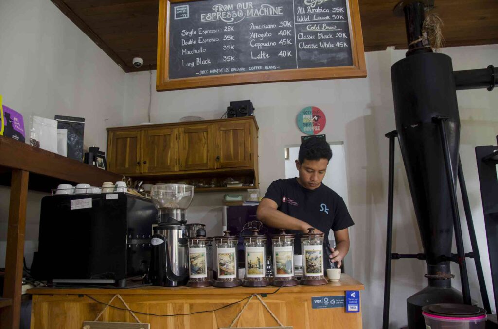 Arya Giri behind a coffee bar in his working area. Photo: pourmorecoffee.com