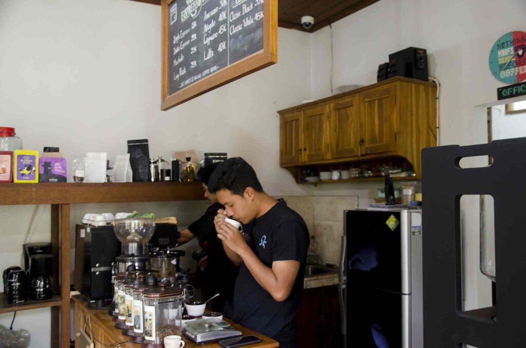 Arya Giri is tasting coffee he has processed. Photo: pourmorecoffee.com